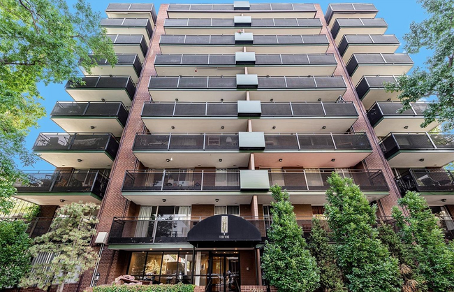 Brick condominium exterior featuring spacious patios, large windows, and beautifully landscaped - 1200 Vine St