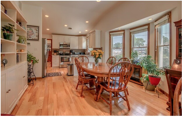Open plan living room, dining area and kitchen with 10' ceilings and lots of windows - 103 Citron St