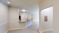 Located at 4 Flycatcher Way in Arden, NC, this 2-bedroom, 2-bathroom residence offers a thoughtfully designed single-floor layout that makes efficient use of its space. The open-concept kitchen and living area serves as the heart of the home, anchored by a granite-topped peninsula with a built-in sink that flows seamlessly into the carpeted living area. The kitchen is equipped with warm wood cabinetry, stainless steel appliances including a refrigerator, range, and microwave, and hardwood-style flooring that adds a polished contrast to the surrounding areas.

Both bedrooms are carpeted and feature ceiling fans, adding comfort and practicality. The primary bedroom is generously sized, boasting crown molding, natural light from large windows with blinds, and a walk-in closet. The second bedroom also benefits from natural light and a closet with built-in hanging storage.

Each of the two bathrooms is finished with granite-topped vanities, warm wood cabinetry, hardwood-style flooring, and shower/tub combinations. The neutral gray tones throughout create a clean, cohesive aesthetic. A hallway connects the rooms efficiently, and two dedicated closets provide ample storage. The overall ambiance is bright, functional, and move-in ready.