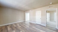 This 550 square foot apartment in Presidential Greens offers a practical and contemporary living space. The unit comprises two bedrooms, one bathroom, a living room, and a kitchen, all efficiently arranged on a single floor. The primary bedroom, measuring 150 square feet, provides ample space for comfort.

The interior boasts a blend of modern finishes, with sleek hardwood flooring in the main living areas and plush carpeting in the bedrooms. Large windows throughout allow for abundant natural light, creating a bright and airy atmosphere. The kitchen features updated appliances and a stylish subway tile backsplash, perfect for culinary enthusiasts.

The bathroom, while compact, is well-appointed with a clean, white color scheme and modern fixtures. The living room serves as the heart of the home, offering a versatile space for relaxation and entertainment. Despite its modest size, the apartment's layout maximizes functionality and comfort.

White walls and trim work provide a neutral backdrop, allowing for personalization in decor. The unit's design emphasizes clean lines and a minimalist aesthetic, contributing to a sense of spaciousness in the compact floor plan. This apartment is ideal for those seeking an efficient, low-maintenance living space in an urban setting.
