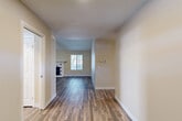 Located at 21495 LeMay Dr in Riverside, CA, this single-story home offers a thoughtfully designed layout across three bedrooms and two bathrooms. Rich wood-look flooring flows through the main living areas, lending warmth and continuity throughout. The open hallway leads into a comfortable living room anchored by a classic fireplace with decorative tile surround and a window that invites natural light. The kitchen is well-appointed with white cabinetry, granite-look countertops, a double basin sink, and a dishwasher, complemented by a separate dining area with access to the patio via sliding glass doors. The spacious primary bedroom features plush carpeting, a ceiling fan, vaulted ceiling details, a sliding glass door to the patio, and a generous walk-in closet with built-in shelving. Additional bedrooms are carpeted and include mirrored closet doors. Both bathrooms are finished with tile flooring, and one features grab bars and a glass-door shower-tub combo with a bright window. The home also includes a pantry, multiple utility spaces, and an oversized attached garage with ample room for storage. With eight closets distributed throughout, storage is plentiful. The patio provides a seamless indoor-outdoor connection, rounding out this functional and inviting Riverside home.