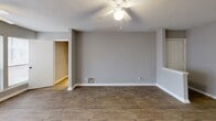 Located at 450 Johnny Mercer Blvd in Savannah, Georgia, this single-floor, three-bedroom, one-bathroom home offers a practical and comfortable layout. The combined kitchen and living room serves as the heart of the home, featuring wood-look plank flooring, neutral gray walls, and a textured ceiling with ceiling fans throughout. Large windows allow natural light to fill the living area, creating a bright and open ambiance. The kitchen includes a peninsula-style breakfast bar, white appliances — including a refrigerator and electric range — wood-accented cabinetry with white fronts, and ample counter space. The bedrooms are carpeted for comfort, each equipped with a ceiling fan and closet storage, including a louvered bi-fold closet door in one room. The bathroom features a full tub-shower combo, a wood-toned vanity with a white countertop, and wood-look tile flooring. Two hallways connect the rooms efficiently throughout the home. The consistent neutral palette, durable flooring, and functional design make this a well-organized and easy-to-maintain residence in the Savannah, GA area.