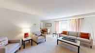 This thoughtfully designed single-floor residence offers a comfortable and efficient layout across its one bedroom and one bathroom. The open living and dining area serves as the heart of the home, featuring neutral-toned carpet flooring, soft natural light, and a sliding glass door that opens to an outdoor balcony with views of greenery and the surrounding neighborhood. The living area provides generous space for seating arrangements, while the adjacent dining space accommodates a full dining table, making it ideal for both everyday living and entertaining.

The kitchen is equipped with warm wood cabinetry, white appliances including a refrigerator and electric range, light tile flooring, and a skylight that adds brightness to the cooking space. A small breakfast bar area adds a casual dining option.

The spacious primary bedroom offers a serene retreat with plush carpet flooring, ample wall space, and direct access to the full bathroom. The bathroom features a combination tub and shower, a vanity with storage, and tile flooring. A dedicated closet provides additional storage within the unit.

Throughout the residence, neutral wall tones and consistent finishes create a cohesive, inviting atmosphere well-suited for comfortable everyday living.