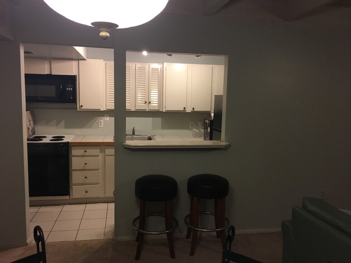 Kitchen with bar and stools - 1008 S College Rd