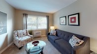 Located at 3404 Middlesex Dr in Toledo, Ohio, this single-floor home offers a practical and comfortable layout across several well-defined living spaces. The living room greets visitors with a large window dressed in sheer curtains, allowing ample natural light to fill the carpeted space, which is complemented by neutral tan walls and room for relaxed seating arrangements. Adjacent to the living area, the dining space features a rich, dark wood table set beneath a set of staggered floating wall shelves, adding a decorative focal point with bold accent pieces. The kitchen is equipped with a gas range, built-in ventilation hood, a double sink, ample white cabinetry with wood-trimmed accents, and tile flooring, all illuminated by a window above the counter. The home includes multiple bedrooms, each finished with soft carpeting, neutral walls, and windows that invite natural light. The primary bedroom is notably spacious, featuring two windows and generous floor space. Additional bedrooms offer cozy, versatile layouts suitable for various uses. The full bathroom is finished with classic white subway tile wainscoting, a tub-shower combo with a window, tile flooring, and a vanity, providing a clean and functional space. Overall, the home presents a cohesive, move-in-ready environment with consistent finishes throughout.