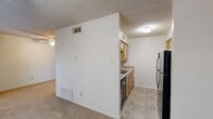 Located at 200 Hann St in Denton, Texas, this single-floor unit offers a practical and efficient layout comprising one bedroom, one bathroom, and a closet. The main living area is generously proportioned relative to the overall footprint, featuring neutral-toned carpet flooring, crisp white walls, and a textured ceiling. A ceiling fan with an integrated light fixture provides both ventilation and illumination, contributing to a comfortable living environment. A large window fitted with horizontal blinds allows natural light to fill the space, creating a bright and open feel.

The bedroom is notably spacious, occupying the majority of the unit's total floor area. It features the same carpet flooring and textured ceiling as the main living area, along with its own ceiling fan. A closet is accessible from within the unit, providing dedicated storage space.

The bathroom is finished with white ceramic subway tile surrounding a full-size bathtub and shower combination. Chrome fixtures add a clean, classic touch, and the white toilet complements the bright, utilitarian aesthetic of the space. The overall design of this unit prioritizes functionality, making it a straightforward and easy-to-maintain space suited for single occupancy in the heart of Denton, TX.