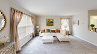 Located at 7 Dumont Ct in Lawrence Township, NJ, this three-story home offers a thoughtfully arranged layout across three levels. The entry-level floor provides a versatile living area with recessed lighting and light hardwood-style flooring, making it an ideal recreational or flex space with natural light streaming through large windows.

The main floor serves as the heart of the home, featuring a bright and spacious living room with plush carpeting, large windows dressed with warm drapes, and an open, airy feel. The kitchen is well-appointed with rich dark wood cabinetry, granite countertops, stainless steel appliances including a dishwasher and gas range, and light wood-style flooring. The kitchen flows seamlessly into an adjoining living area, enhancing the open-concept feel.

The upper floor houses all three bedrooms and two bathrooms. The bedrooms feature soft carpeting, ample closet space with sliding doors, and windows that invite natural light. The bathrooms are clean and bright, with one featuring a granite-topped vanity. A dedicated laundry area with a full-size washer and dryer adds everyday convenience. Carpeted stairs with white railings and a wood handrail connect the floors, contributing to the home's warm, welcoming character throughout.