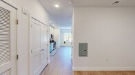 Located at 37 N York Rd in Hatboro, PA, this single-floor studio unit offers a thoughtfully designed layout that maximizes functionality within a compact footprint. The open living area features light-toned hardwood-style flooring and crisp white walls, creating a bright, clean aesthetic throughout. Recessed lighting provides consistent illumination, while a large picture window floods the space with natural light and offers views of the surrounding area, enhancing the sense of openness.

The kitchen is a standout feature, outfitted with floor-to-ceiling white cabinetry that provides generous storage. Dark granite countertops contrast elegantly with the white subway tile backsplash, and the space is equipped with a full suite of stainless steel appliances, including a refrigerator, electric range, over-the-range microwave, and dishwasher. The layout is efficient and well-organized, making the most of the available space.

The bathroom continues the modern aesthetic with large-format beige tile flooring, a white vanity with dark granite countertop and under-sink storage, a wide mirror, and clean white walls. The layout is practical and uncluttered. Overall, the unit presents a contemporary, move-in-ready living environment with consistent finishes and a bright, neutral palette throughout.