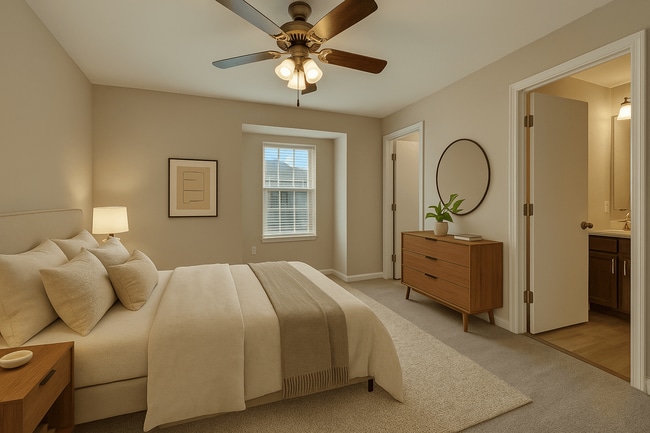 A bedroom with a large bed and a ceiling fan. - Canterbury Apartments