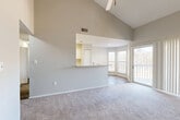 Located at 6609 Reafield Dr in Charlotte, NC, this 2-bedroom, 2-bathroom home offers a well-designed single-floor layout. The living room is a standout space, featuring dramatic vaulted ceilings with a ceiling fan and soft carpeting underfoot. A tile-surround fireplace anchors one wall, while a sliding glass door opens directly onto a private balcony, filling the room with natural light and offering pleasant outdoor views. The open-concept kitchen connects seamlessly to the living area via a pass-through bar with marble-look countertops. The kitchen is equipped with white cabinetry, a subway tile backsplash, stainless steel appliances, and a built-in pantry. Wood-look flooring extends through the kitchen and dining area. The primary bedroom is a comfortable retreat with carpeted flooring, a window for natural light, and dedicated closet space. The second bedroom is equally well-sized, also featuring carpet and a textured ceiling. Both bathrooms include a full tub-shower combo with white tile surround, marble-look vanity tops, and wood-look flooring. A hallway connects the bedrooms and bathrooms, with two closets providing ample storage throughout the home.