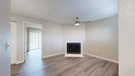 Located in Clearwater, FL, this well-appointed one-bedroom, one-bathroom residence offers a thoughtfully designed single-floor layout. The open living room serves as the heart of the home, featuring a white-surround fireplace, a ceiling fan with light, and smooth wood-look flooring that carries throughout the space. Vertical blinds provide access to an outdoor area, allowing natural light to filter in and offering views of surrounding greenery.

The galley-style kitchen is both functional and stylish, outfitted with white shaker cabinetry, light quartz countertops, and a full suite of stainless steel appliances including a refrigerator, electric range, microwave, and dishwasher. A tray ceiling with built-in lighting adds architectural interest overhead.

The bedroom is a comfortable retreat, featuring its own ceiling fan, wood-look flooring, and a sliding glass door with vertical blinds that opens to an outdoor area with pleasant green views. Ample closet space is also provided.

The bathroom is clean and modern, featuring a white vanity with quartz countertop, a tub-shower combination with white tile surround, and wood-look flooring that ties the space together cohesively. The neutral palette and updated finishes give the entire residence a fresh, move-in-ready feel.