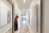 Located in Fort Oglethorpe, GA, this well-appointed 2-bedroom, 2-bathroom single-story home offers a thoughtfully designed layout with modern finishes throughout. Light wood-tone flooring flows through the interior, complemented by bright white walls and recessed lighting that create a clean, contemporary feel.

The entryway welcomes you with a long hallway adorned with framed artwork and a practical wall hook, setting a polished tone. The open-concept kitchen and living area serves as the heart of the home. The kitchen is outfitted with crisp white shaker cabinetry, subway tile backsplash, stone-look countertops, stainless steel appliances, and a peninsula with sink — ideal for both cooking and casual dining.

The primary bedroom is generously proportioned, featuring large windows that bring in ample natural light and an en suite bathroom with a wide granite-topped vanity and hardwood-style flooring. The second bedroom also enjoys natural light from a sizable window. A full second bathroom mirrors the same refined design as the primary bath.

Three closets offer excellent storage, while a dedicated laundry area adds everyday convenience. The attached garage provides secure parking and additional utility space with an automatic door opener and electrical panel access. This home combines efficient use of space with modern design in a single-level layout.