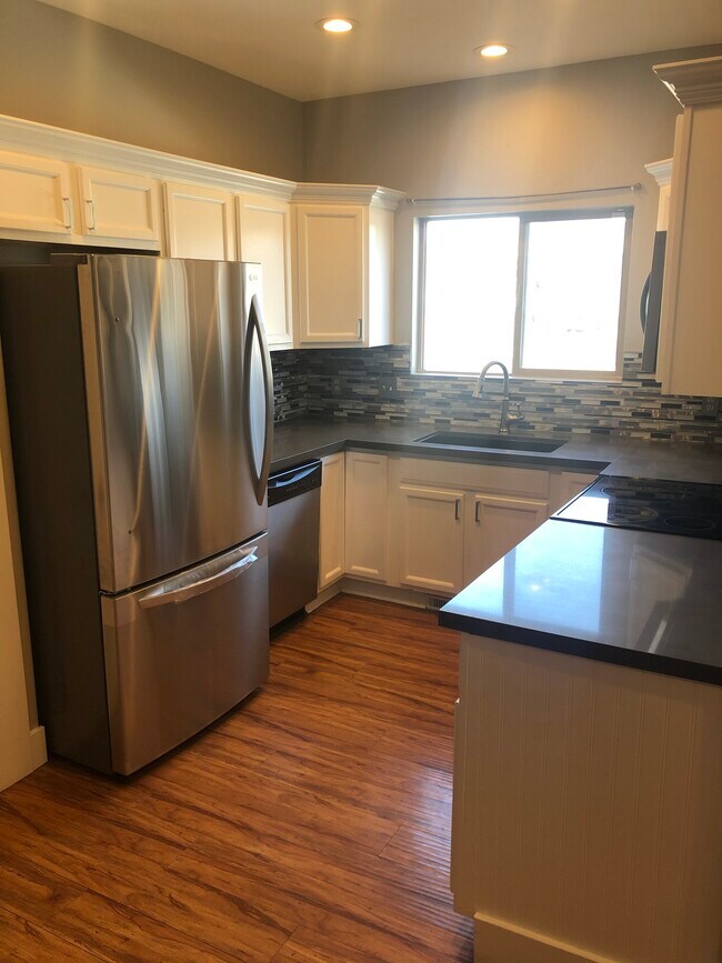 Brand new stainless steel refrigerator, quartz counters and deep farmhouse style sink. - 2128 W 2180 North,