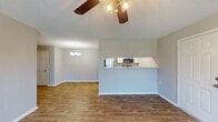 This single-story home in Olive Branch, Mississippi, offers a practical and comfortable layout across three bedrooms and two full bathrooms. The open-concept living and dining area is finished with warm wood-look flooring and features ceiling fans with integrated lighting fixtures. A chandelier over the dining space adds a welcoming touch, while a pass-through peninsula connects the living area to the kitchen, enhancing the sense of openness.

The kitchen is outfitted with crisp white cabinetry, marble-look countertops, and stainless steel appliances including a range, over-the-range microwave, and refrigerator. The clean, neutral finishes create a functional and visually cohesive cooking space.

The bedrooms are carpeted for comfort and each includes a ceiling fan with lighting. Natural light enters through windows with blinds, and closets provide practical storage. The primary bedroom features direct access to an adjoining room, likely a dedicated bathroom or hallway. Both bathrooms are simply appointed with standard fixtures, tub-shower combinations, and white cabinetry. Neutral gray tones throughout the home create a calm, cohesive ambiance well-suited for easy personalization.