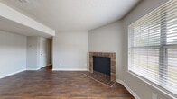 Located in Chattanooga, TN, this single-story home offers a well-designed layout with a blend of practical features and thoughtful finishes throughout. The living room serves as the centerpiece of the home, showcasing rich, dark hardwood-style flooring, neutral gray walls, and a classic brick fireplace that adds warmth and character to the space. Natural light filters in through blinded windows, complementing the open, airy feel of the room. A textured ceiling adds depth throughout the main living areas.

The kitchen is a standout feature, outfitted with dark espresso-toned cabinetry, granite countertops, and a stylish mosaic tile backsplash. Ample cabinet storage and generous counter space make this kitchen as functional as it is visually appealing, with hardwood-style flooring continuing the cohesive design.

The bedrooms are comfortably appointed with soft, neutral carpeting and ceiling fans, each receiving natural light through blinded windows. The bathrooms are clean and efficiently designed, featuring tub-shower combinations with chrome fixtures and vanities with granite countertops. A louvered closet door adds a classic touch to the hallway area. Overall, this home presents a cohesive, move-in-ready interior with updated finishes throughout.