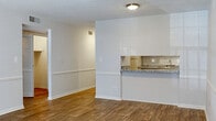 This one-bedroom, one-bathroom apartment at Bell Oaks Apartments in Montgomery, Alabama offers a well-organized single-story layout designed for comfortable everyday living. Throughout the unit, wood-look flooring provides a warm, cohesive aesthetic that connects each area of the home.

The living area is generously proportioned and features a pass-through opening to the kitchen, creating an open, connected feel between the two spaces. A chair rail detail runs along the walls, adding a subtle architectural element to the living and dining areas. The living space also includes direct access to the outdoors via a private exterior door, accompanied by a large window that allows natural light to fill the room.

The kitchen is equipped with white cabinetry featuring brushed hardware, granite-style countertops, a stainless steel sink, and a freestanding electric range. Ample upper and lower cabinet storage makes the kitchen both functional and practical.

The bedroom is a comfortable, well-lit room with a ceiling fan, a window with blinds, and continued wood-look flooring. The full bathroom includes a granite-topped vanity with an undermount sink, a tub-shower combination with tile surround, and wood-look flooring. Textured ceilings are present throughout the unit.