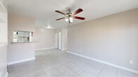 Located at 8323 Cinnamon Ln in Houston, TX, this single-story 2-bedroom, 2-bathroom home offers a practical and comfortable layout designed for everyday living. Light-toned tile flooring runs throughout the entire home, creating a clean and cohesive aesthetic. The combined living and dining area is bright and open, featuring a ceiling fan with light fixture and easy flow into the kitchen. The kitchen is equipped with a peninsula breakfast bar topped with granite-style counters, gray cabinetry, tile backsplash, and white appliances including a refrigerator and dishwasher, with a dedicated pantry providing additional storage. Both bedrooms are well-proportioned, each featuring ceiling fans, tile flooring, and windows that allow natural light to filter in. The primary bedroom includes access to a walk-in closet with built-in shelving. The bathrooms are finished with granite-top vanities and neutral tiled tub-surround enclosures accented with mosaic tile detailing. The home also includes a dedicated laundry area and five closets total, offering exceptional storage throughout. A dedicated dining space and an open living room layout make this home functional and inviting.