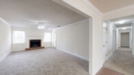 Located on Airport Blvd in Mobile, Alabama, this single-story home offers three bedrooms and three bathrooms across a well-organized floor plan. The living room serves as the heart of the home, highlighted by a classic brick fireplace, plush carpet flooring, crown molding, a ceiling fan, and a textured ceiling. An open archway connects the living area to the rest of the home, creating a seamless flow throughout. The dining room features warm hardwood flooring, crown molding, a large window that invites natural light, and an elegant multi-light chandelier overhead. The dedicated laundry room is equipped with dark cabinetry, a countertop workspace, and tile flooring for easy maintenance. The bathrooms are clean and functional, with tiled shower-tub combinations and tile flooring. Each bedroom is carpeted and fitted with a ceiling fan and crown molding; the secondary bedrooms offer comfortable proportions with natural light from windows, while the generously sized primary bedroom includes access to a walk-in closet outfitted with multi-tier wire shelving for ample storage. Neutral tones and consistent finishes throughout lend the home a cohesive, move-in-ready feel.