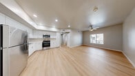 Located at 651 McKnight St in Las Vegas, NV, this well-appointed one-bedroom, one-bathroom unit offers a clean, modern design across a single floor. The open-concept kitchen and living area serves as the heart of the space, featuring light wood-look flooring that flows seamlessly throughout. The kitchen is outfitted with white shaker-style cabinetry, ample upper and lower storage, light countertops, and a full suite of stainless steel appliances including a refrigerator, gas range, microwave, dishwasher, and sink — delivering both style and functionality. The living area is bright and open, providing a versatile layout for everyday living. The bedroom is a comfortable, well-proportioned room with a ceiling fan, a window fitted with blinds that allows natural light, and a spacious sliding-door closet offering generous storage. The bathroom is designed with accessibility in mind, featuring a walk-in shower with built-in shelving, grab bars, and light wood-look flooring. A hallway connects the main living spaces efficiently. The unit's neutral color palette, clean lines, and consistent flooring create a cohesive and inviting atmosphere throughout.
