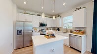 Located at 2350 N Narcoossee Rd in Saint Cloud, Florida, this two-story home offers a well-designed layout across two floors. The main level features a welcoming entrance that opens into a bright living room with light wood-style flooring and clean white walls. The open-concept kitchen and dining area are thoughtfully connected, with the kitchen showcasing white cabinetry, stainless steel appliances including a full-size refrigerator and electric range, and light countertops. The dining space enjoys natural light from large windows with outdoor views. A pantry and laundry room with washer and dryer add everyday convenience on this level, alongside a garage with an automatic opener.

Upstairs, the primary bedroom features a tray ceiling, multiple windows that invite natural light, and generous closet space with built-in wire shelving systems. All four bathrooms are finished in neutral tones with tile flooring, and at least one includes a tub-shower combination with gold-tone fixtures. The home includes eight closets in total, providing excellent storage throughout. A staircase connects the two floors, with the upper level housing the majority of the living space. The overall design is clean, bright, and functional, making it well-suited for comfortable everyday living.