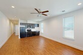 Located at 3933 Muriel Say Ave in Baton Rouge, Louisiana, this single-story, 2-bedroom, 2-bathroom home offers a clean, functional layout with consistent wood-look flooring throughout. The open-concept living and kitchen area forms the heart of the home, featuring recessed lighting, a ceiling fan, and multiple windows that allow natural light to fill the space. The kitchen is outfitted with dark cabinetry, black appliances including a refrigerator, range, and built-in microwave, along with a sink positioned beneath a window.

Both bedrooms are bright and well-proportioned, each equipped with a ceiling fan and closet. The primary bedroom includes a dedicated closet and direct access to one of the two bathrooms, providing added privacy and convenience. The second bedroom is similarly comfortable with its own ceiling fan and closet access. A hallway connects the rooms, contributing to a practical flow throughout the home.

The two bathrooms are finished with wood-look tile flooring and dark vanity cabinetry. One bathroom features a tub-shower combination with built-in shelving, while the other offers a clean, straightforward layout with a window for natural ventilation. The overall design of the home is understated and move-in ready, with white walls and neutral finishes throughout.