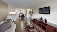 Located at 175 S Rio Vista St in Anaheim, California, this single-floor residence offers a well-organized layout designed for comfortable everyday living. The open-concept living and dining area is a standout feature, with wood-style flooring that flows seamlessly throughout the main spaces. Natural light filters in through large windows fitted with vertical and horizontal blinds, creating a bright and welcoming atmosphere. A ceiling fan in the dining area adds both style and functionality to the space.

The kitchen is efficiently designed with white cabinetry, ample counter space, a gas range, and a double-basin sink — providing everything needed for meal preparation. A pass-through counter connects the kitchen to the living and dining area, enhancing the open feel of the home.

The bedrooms feature plush carpeting, windows with blinds for light control, and wall-mounted air conditioning units. Each room offers a calm, restful environment with neutral wall tones throughout.

The bathroom presents a long vanity with generous counter space, white cabinetry, wood-style flooring, and a separate tub-shower combination. The layout is practical and clean, with well-maintained fixtures. Overall, this residence combines functional design with comfortable finishes in a convenient Anaheim location.