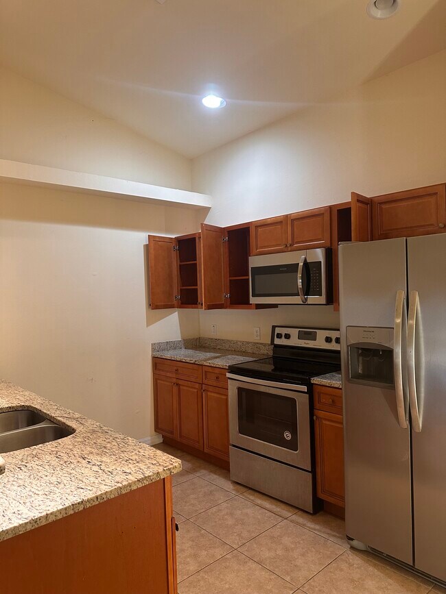 Kitchen with stove/oven, fridge and microwave - 4427 SW 9th Ave