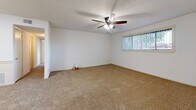 Located at 2330 N Oliver St in Wichita, Kansas, this single-floor unit offers two bedrooms and three bathrooms within a well-organized, functional layout. The open kitchen features white cabinetry, dark granite-style countertops, a peninsula with additional counter space, and black appliances including a refrigerator and range. The kitchen flows into a carpeted living area, creating a connected and practical common space. A ceiling fan with lighting is installed in the living area, which also benefits from natural light through a window with vertical blinds. Both bedrooms are carpeted and finished with clean white walls and textured ceilings. The primary bedroom is generously sized and includes a dedicated closet, while the second bedroom offers its own window with natural light. The three bathrooms feature wood-look flooring, white cabinetry, and speckled countertops with single-basin sinks and mirrors. The bathrooms are clean and simply appointed, providing a functional and tidy aesthetic throughout. The overall design of the unit is straightforward and neutral, with consistent finishes across rooms including beige carpet, white walls, and warm-toned surfaces that lend a cohesive, move-in-ready feel to the entire space.
