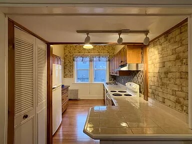 Kitchen with bar counter, laundry in closet on left - 167 Coggeshall Ave