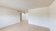 Located at 1655 Blue Bell Rd in Houston, TX, this single-floor, 2-bedroom, 2-bathroom unit offers a practical and well-organized layout. The open living, dining, and kitchen area forms the heart of the home, featuring light wood-style flooring and a textured ceiling throughout. Natural light filters in through slatted blinds, brightening the neutral-toned walls and creating a clean, airy atmosphere.

The galley-style kitchen is efficiently designed with ample gray cabinetry, white countertops, a stainless steel sink, and stainless steel appliances including an electric range and refrigerator. A dedicated pantry provides additional storage. The kitchen flows seamlessly into the living and dining area, making the space feel connected and functional.

Both bedrooms are carpeted and equipped with ceiling fans, offering comfort and coziness. The primary bedroom is generously proportioned and includes closet space. The secondary bedroom features a window with outdoor views, filling the room with natural light. Three closets throughout the unit provide ample storage.

The bathrooms include a full tub-shower combo with warm beige tile surround and chrome fixtures, conveying a clean and classic finish. The unit's straightforward, well-maintained design makes it a practical and comfortable home in the Houston area.