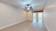 Located on King Street in Charleston's historic 29403 zip code, this single-floor, 4-bedroom, 2-bathroom home offers a well-designed layout with a clean, modern aesthetic. The living room is bright and open, featuring a ceiling fan, recessed lighting, and light-toned luxury vinyl flooring that flows throughout the common areas. A wide hallway connects the rooms, accented by louvered closet doors and a neutral palette that enhances the sense of openness.

The kitchen is thoughtfully appointed with white shaker cabinetry, quartz countertops, a peninsula with a double stainless steel sink, subway tile backsplash, and a full suite of stainless steel appliances. The four bedrooms offer versatility, with several rooms showcasing a charming painted exposed brick accent wall and windows that bring in natural light and garden views. Ceiling fans are present in multiple rooms, contributing to comfortable year-round living.

Both bathrooms are finished in a clean, contemporary style with white cabinetry, wood-look tile flooring, and tub-shower combinations. Additional storage is provided by a dedicated closet. The home's combination of historic character elements and modern finishes makes it a distinctive offering in one of Charleston's most sought-after neighborhoods.