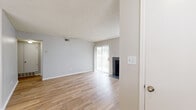 Located along East Colorado Avenue in Denver, CO, this 1-bedroom, 1-bathroom residence offers a functional and comfortable single-floor layout. The living room is a standout space, featuring light hardwood-style flooring, a tile-surround fireplace, and a sliding glass door that floods the room with natural light and provides outdoor access. A textured ceiling and neutral gray walls carry throughout, creating a clean, cohesive aesthetic. A ceiling fan adds both style and practicality to the secondary area near the entry.

The galley-style kitchen is efficiently designed with white cabinetry, light stone countertops, a stainless steel sink, dishwasher, and refrigerator, plus an electric range — providing ample functionality in a compact footprint. Hardwood-style flooring continues seamlessly from the living areas into the kitchen.

The bedroom offers plush carpeting, a textured ceiling, a dedicated closet, and a vertical blind-covered window that allows for natural light while maintaining privacy. The full bathroom features a single-sink vanity with a dark granite-style countertop, white cabinetry, a tiled tub-shower combo, and hardwood-style flooring. A hallway connects the main living areas, completing this well-organized and move-in-ready Denver residence.