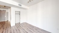 Located at 1400 S Figueroa Street in the heart of Los Angeles, this modern single-floor unit offers a clean, contemporary aesthetic throughout. The space is unified by durable wood-look plank flooring that flows seamlessly from room to room, complementing the crisp white walls and lending the interior a bright, cohesive feel.

The kitchen is a standout feature, designed with functionality and style in mind. White cabinetry — including upper glass-front accent cabinets and tall pantry storage — pairs with gray stone countertops and a mosaic tile backsplash in soft blue and neutral tones. A full suite of stainless steel appliances includes a gas range, over-the-range microwave, refrigerator, and dishwasher, making this kitchen both practical and visually polished.

The living and sleeping areas are open and versatile, bathed in natural light from large windows with sheer drapery. Track lighting provides flexible overhead illumination. One of the rooms features direct access to a glass-door balcony, extending the living space and inviting in natural light and urban views. Built-in closet space with a rod and shelf adds practical storage.

The unit's overall ambiance is modern and move-in ready, with a neutral palette that offers a blank canvas well-suited to a variety of interior styles. Its prime South Park location places residents close to major Los Angeles landmarks and transit options.