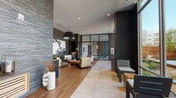 This thoughtfully designed single-floor amenity space blends modern aesthetics with a serene, spa-like atmosphere. The welcoming lounge area greets visitors with a striking combination of stacked stone accent walls, rich hardwood flooring, and large-format tile, creating a refined yet inviting environment. Carefully curated seating arrangements — featuring leather and upholstered chairs paired with solid wood coffee tables — offer comfortable gathering spaces, while a dramatic pendant light fixture anchors the room's contemporary design.

A large-scale black-and-white tree mural adorns one wall, adding an artistic focal point that complements the warm wood slat paneling and open shelving nearby. Floor-to-ceiling glass walls and expansive windows flood multiple areas with natural light and provide views of the landscaped outdoor courtyard, seamlessly connecting the interior to the outside environment.

The indoor pool area is a standout feature, enclosed by a full wall of steel-framed glass that frames views of the courtyard and surrounding architecture. The pool is finished with mosaic tile accents and is accessible via stainless steel handrails, set against a backdrop of natural stone tile walls.

A dedicated shower area features floor-to-ceiling marble-look porcelain tile and chrome fixtures, rounding out the spa-quality experience. Together, these spaces create a cohesive, upscale retreat centered on relaxation and wellness.