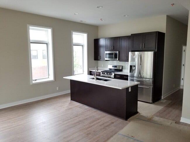 Kitchen with island and full suite of stainless steel appliances - 1548 119th St