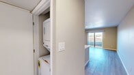 Located at 4816 McMahon Blvd NW in Albuquerque, New Mexico, this one-bedroom, one-bathroom unit offers a well-organized single-floor layout designed for comfortable everyday living. The open-concept kitchen and living room serve as the heart of the home, featuring a large peninsula with a double-basin undermount sink and light quartz-style countertops, white shaker cabinetry, stainless steel appliances including a refrigerator and gas range, and light wood-style flooring that flows throughout the entire unit. A flush ceiling light fixture brightens the kitchen space, which also includes a built-in electrical panel for added convenience. The living area extends naturally to a private balcony through sliding glass doors, bringing in natural light and outdoor views. The bedroom is a well-proportioned retreat finished with the same warm wood-style flooring, neutral wall tones, a mirrored sliding closet, and a window with blinds that allows for natural light. Built-in shelving provides additional storage options. The hallway connects all areas of the unit with ease. The bathroom is clean and functional, featuring a full tub-shower combo with white subway tile surround, brushed nickel fixtures, and wood-style flooring that ties the space together cohesively. The overall aesthetic is modern, neutral, and move-in ready.