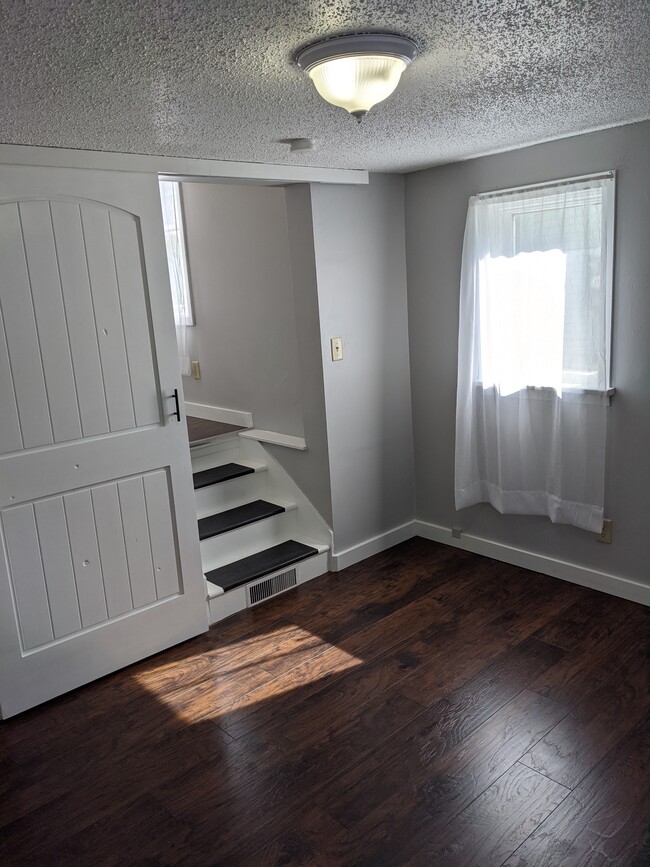 Very spacious bedroom with brand new flooring. - 1500 8th Ave NE