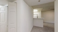 Located in the North Hollywood neighborhood of Los Angeles, this single-story 3-bedroom, 2-bathroom residence offers a practical and well-organized layout. The open living area is carpeted throughout and features a ceiling fan, a sliding glass door that invites natural light and provides access to an outdoor balcony with views of the surrounding greenery. The kitchen is efficiently designed in a galley style, featuring white cabinetry, a stainless steel sink, white appliances including a range, built-in microwave, dishwasher, and refrigerator, all set atop wood-look flooring. A peninsula counter connects the kitchen to the adjacent living space, enhancing the open feel. The primary bedroom is generously sized, featuring soft carpet, a window for natural light, and closet access. The additional bedrooms are well-proportioned, each with carpet flooring and windows. Both bathrooms are finished in a clean, bright white palette with wood-look flooring, vanities with light countertops, and full tub/shower combinations. A hallway connects the bedroom wing to the main living areas, with two closets providing ample storage. Textured ceilings are consistent throughout the home, adding a classic residential character to this move-in ready Los Angeles residence.