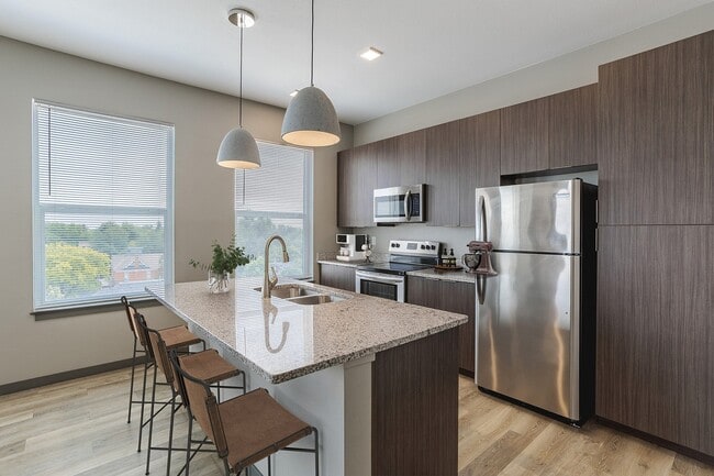 Beautiful Kitchen with Island - Patina Flats at the Foundry Apartments