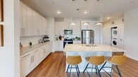 This contemporary 1-bedroom apartment in Cedar Heights offers 1000 square feet of thoughtfully designed living space. The efficient single-floor layout maximizes functionality with an open-concept design. The gourmet kitchen boasts white cabinetry, granite countertops, and stainless steel appliances, complemented by a convenient island with seating. The living area is flooded with natural light from large windows and features modern furnishings and a striking blue accent wall.

The spacious primary bedroom, measuring 160 square feet, includes a ceiling fan and ample closet space. The apartment boasts three well-appointed bathrooms, each with sleek fixtures and glass-enclosed showers. Hardwood floors run throughout, adding warmth and continuity to the space.

Additional amenities include in-unit laundry and custom closet systems. The interior design showcases a harmonious blend of neutral tones with pops of color, creating a stylish and inviting atmosphere. Artwork and carefully curated decor elements add personality to each room, making this apartment a perfect blend of comfort and contemporary urban living.
