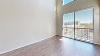 Located at 1105 Town Blvd NE in Brookhaven, GA, this two-story, one-bedroom, one-bathroom residence offers a thoughtfully designed layout spread across two levels. The main floor welcomes you through a bright entrance into an open-concept living and dining area, where large windows and sliding glass doors flood the space with natural light and provide views of the surrounding Brookhaven neighborhood. The kitchen is a standout feature, equipped with rich dark-wood cabinetry, granite countertops, stainless steel appliances including a refrigerator, range, and built-in microwave, a subway tile backsplash, and hardwood-style flooring. A private balcony extends the living space outdoors. The bedroom is carpeted and generously sized, benefiting from natural light and direct balcony access. A walk-in closet offers ample wire-rack storage. The bathroom features large-format tile flooring, a dark vanity with granite countertops, and access to the walk-in closet. Upstairs, a carpeted loft area with an open metal railing and ceiling fan provides flexible additional living space. A laundry area and utility room add everyday convenience. This well-appointed residence combines modern finishes with a functional two-story layout.