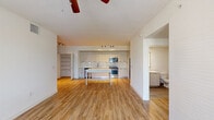 Located at 11020 Town Circle in Royal Palm Beach, FL, this single-story, 3-bedroom, 2-bathroom home offers a clean, modern aesthetic throughout. The open-concept kitchen and living area serves as the heart of the home, featuring sleek white cabinetry, subway tile backsplash, stainless steel appliances, and warm light wood flooring that extends seamlessly into the living space. A ceiling fan overhead and a central kitchen island add both comfort and functionality to the layout. The living area is bright and airy, with natural light flowing in through windows with slatted blinds and a glass-paneled door that offers views of the outdoors. The bedrooms are carpeted for comfort, with the primary bedroom offering generous proportions, direct access to a private bathroom, and a dedicated closet. The secondary bedrooms are well-sized with large windows that bring in natural light. Both bathrooms are finished with white subway tile tub surrounds, wood-look tile flooring, and modern vanities with clean white countertops. A hallway connects the rooms efficiently, contributing to a practical and well-organized floor plan. The overall ambiance is bright, neutral, and move-in ready.