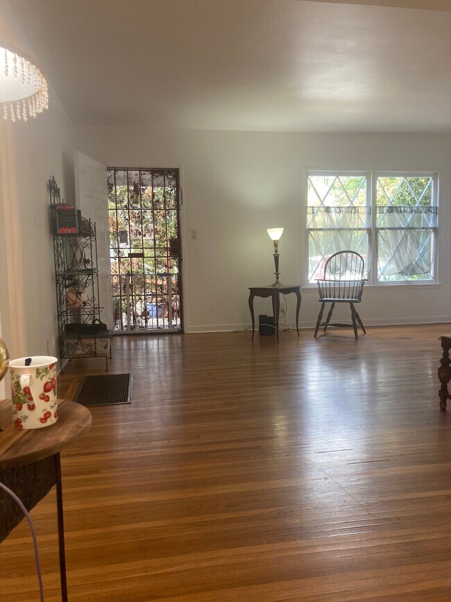 Living room L-shape approx 17' x 30' w 12' x 9' cutout)- Note hardwood flooring and windows - 11924 Tennessee Pl