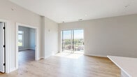 Located at 440 Green Bay Rd in Highwood, IL, this thoughtfully designed 2-bedroom, 2-bathroom residence offers a clean, modern aesthetic throughout. Light-toned wood plank flooring flows seamlessly across the entire unit, lending warmth and continuity to every room.

The open-concept living and kitchen area is a standout feature, anchored by a sleek kitchen with a central island beneath a geometric pendant light fixture. White upper cabinetry is paired with natural wood-toned lower cabinets, complemented by a classic subway tile backsplash and stainless steel appliances including a gas range, microwave, and refrigerator. A sliding glass door in the living area connects to an outdoor space and floods the interior with natural light.

Both bedrooms are bright and well-proportioned. The primary bedroom includes a double-door closet, while additional bedrooms feature large windows with elevated views of the surrounding Highwood neighborhood and glimpses of the horizon beyond.

The two bathrooms are finished in a consistent modern style, each featuring neutral tile flooring, wood-toned vanity cabinetry, white quartz countertops, framed mirrors with contemporary lighting, and a tub-shower combination with clean white tile surrounds. The overall palette of soft whites and warm neutrals creates a calm, move-in-ready environment throughout.