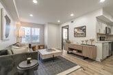 Located at 5811 Poplar Avenue in Memphis, TN, this thoughtfully designed one-bedroom, two-bathroom unit maximizes every square foot with a clean, modern aesthetic. The open-concept living and kitchen area serves as the heart of the home, featuring light wood-toned flooring, crisp white walls, and recessed lighting that creates a bright, welcoming atmosphere. Natural light filters in through multiple windows fitted with horizontal blinds. The kitchen is well-appointed with white shaker cabinetry, quartz countertops, a classic subway tile backsplash, and a full suite of stainless steel appliances including a range, microwave, dishwasher, and refrigerator. The living area offers a comfortable layout with ample room for seating and entertaining. The bedroom is a peaceful retreat, accommodating a full-sized bed with ease, and includes a ceiling fan, a window for natural light, and warm neutral tones throughout. The two bathrooms are finished with white cabinetry, quartz vanity tops, framed mirrors, and light wood flooring. One bathroom features a full soaking tub with tiled surround. The space combines functional design with contemporary finishes for comfortable urban living.