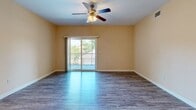 Located in Fort Walton Beach, Florida, this single-story, 4-bedroom, 2-bathroom home offers a well-designed layout with functional spaces throughout. The open-concept kitchen and living area serves as the heart of the home, featuring warm wood cabinetry, granite-style countertops, a tile backsplash, pendant lighting, and a peninsula with a double sink. Black appliances, including a refrigerator, range, microwave, and dishwasher, complete the kitchen. Wood-look flooring runs through the main living areas, adding a clean and cohesive aesthetic. The spacious living room is brightened by natural light and a ceiling fan, and opens directly to a private balcony through sliding glass doors, offering pleasant outdoor views. The four bedrooms are comfortably sized, with the primary bedroom offering generous space, while the secondary bedrooms feature plush carpeting, ceiling fans, and windows that invite natural light. Both bathrooms include warm wood vanities with white countertops and full tub-shower combinations. A dedicated laundry room with wire shelving, washer/dryer hookups, and wood-look flooring adds convenience. Three closets and a hallway complete this efficiently organized home.