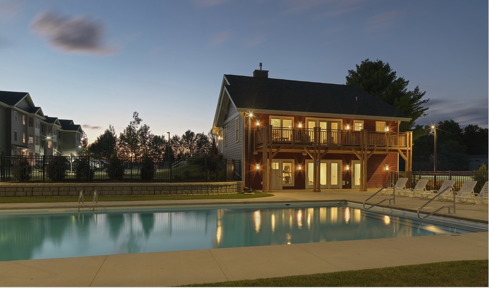 Piscina y casa club en la noche - Village at Autumn Pond