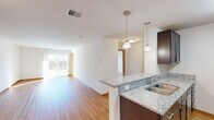 This 710 square foot apartment offers a thoughtful layout maximizing functionality in a compact space. The open-concept kitchen and living area create an airy feel, enhanced by warm hardwood flooring throughout. The kitchen boasts modern dark wood cabinetry, sleek granite countertops, and stainless steel appliances, including a side-by-side refrigerator and built-in microwave.

The spacious bedroom, measuring 160 square feet, features plush carpeting and a large window allowing ample natural light. A sliding glass door in the living area leads to an outdoor space, extending the living area and providing a connection to the exterior.

The bathroom is well-appointed with a granite-topped vanity, matching the kitchen's aesthetic. A dedicated closet space offers additional storage solutions. Throughout the apartment, recessed lighting and pendant fixtures provide a contemporary ambiance.

This efficient single-floor layout is ideal for individuals or couples seeking a low-maintenance lifestyle without sacrificing modern amenities. The property's location at 6652 N Towne Rd in Windsor, Wisconsin, offers a blend of suburban tranquility and urban convenience.
