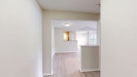 Located at 570 Church St E in Brentwood, Tennessee, this well-appointed 2-bedroom, 2-bathroom unit offers a thoughtfully designed single-level layout. The open-concept kitchen and living area serves as the heart of the home, featuring granite countertops, white cabinetry with a classic subway tile backsplash, stainless steel appliances including a dishwasher and range, and a peninsula that provides additional prep and dining space. Light wood-style flooring runs throughout the main living areas, complementing the bright, neutral color palette. The living room is bathed in natural light from large windows and a sliding glass door that opens onto a private balcony with outdoor views. Track lighting adds a functional accent overhead. Both bedrooms are generously sized, carpeted for comfort, and each equipped with a ceiling fan and a well-proportioned window that brings in natural light. The primary bedroom offers a comfortable retreat with ample space. Both bathrooms are finished with granite-topped vanities, white cabinetry, and light wood-style tile flooring, with a full tub and shower combination. A hallway connects the rooms efficiently, rounding out a functional and cohesive floor plan suited for comfortable everyday living.
