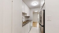Located at 1903 Bayview Ave in Toronto's desirable Leaside neighbourhood, this two-bedroom, one-bathroom unit offers a well-organized and functional layout across a single floor. Warm parquet flooring flows throughout the living areas and bedrooms, lending a classic character to the space. The bright and open living room provides ample room for comfortable furnishing and connects seamlessly to the galley-style kitchen, which features white shaker cabinetry, subway tile backsplash, stainless steel appliances, and light tile flooring. Both bedrooms are well-proportioned, each equipped with full-width sliding closets and windows that invite natural light. The primary bedroom offers a generous footprint with views of the surrounding greenery. The bathroom has been thoughtfully updated with subway tile surrounding the bathtub, a modern vanity, and neutral stone-look floor tiles. A private balcony extends the living space outdoors, offering pleasant views of mature trees and the Toronto skyline in the distance. The hallway provides a practical entry and connects all rooms efficiently, completing this clean and move-in ready home.